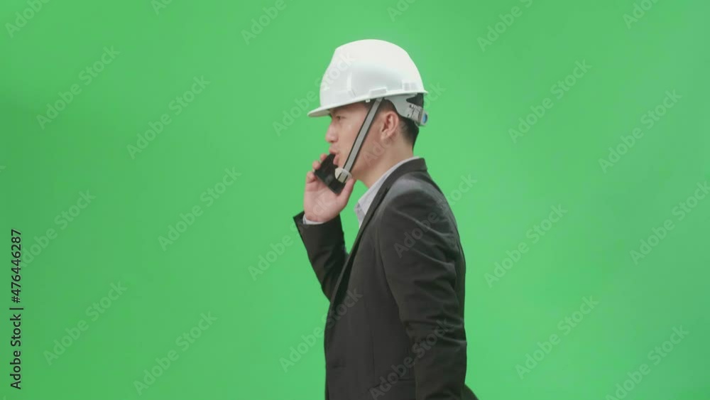 Side View Of Asian Chief Engineer In The Hard Hat Talking On Mobile Phone While Walking On Green Screen Chroma Key
Side View Of Asian Chief Engineer In The Hard Hat Talking On Mobile Phone While Walking On Green Screen Chroma Key