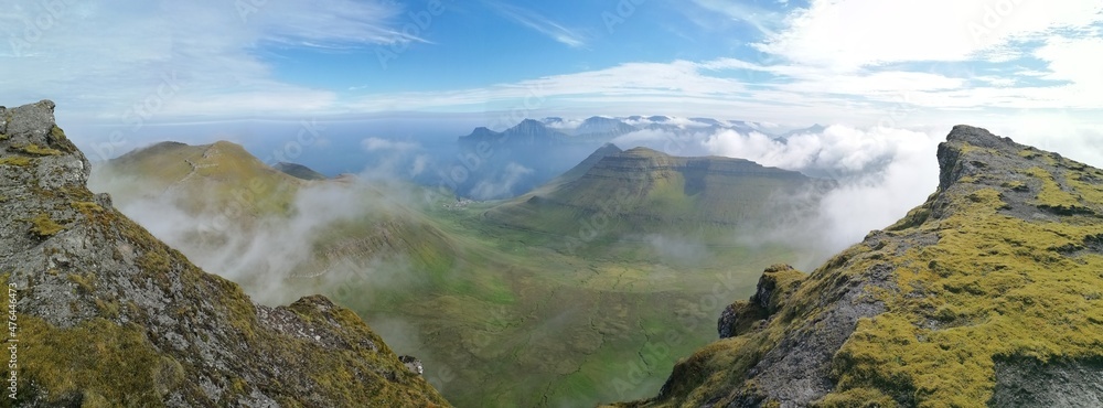 Obraz premium Stunning mountain views in the green and lush hills of the Faroe Islands in the Atlantic Sea