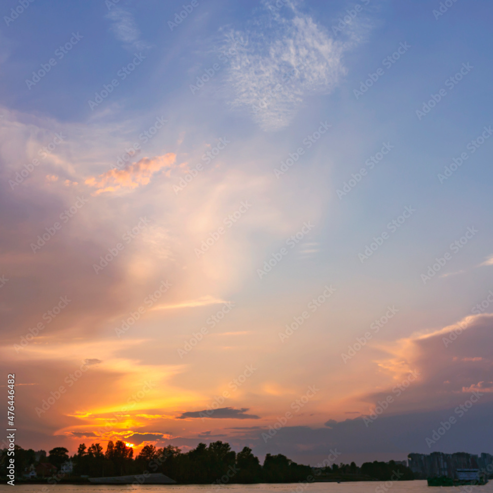 beautiful cirrus clouds illuminated by the setting summer sun