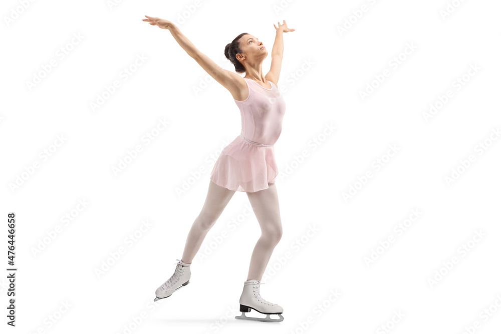 Young female in a pink dress performing ice skating