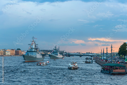 Modern warships. Tourists from pleasure ships and the embankment look at the warships on the Neva. Before the naval parade in St. Petersburg, Russia