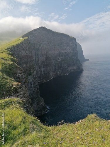 Stunning mountain views in the green and lush hills of the Faroe Islands in the Atlantic Sea