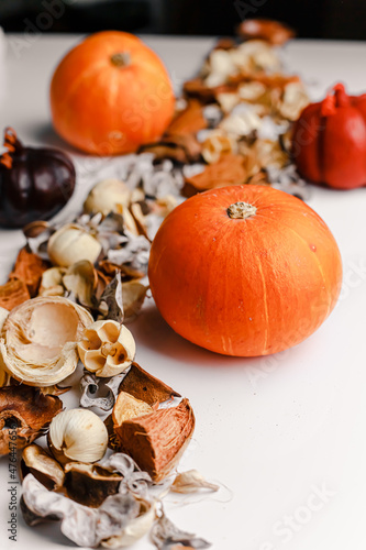 Hello Autumn or Happy Thanksgiving concept. Orange candles with pumpkins at the background, knitted plaid and autumnal leaves. Shallow depth of field. 