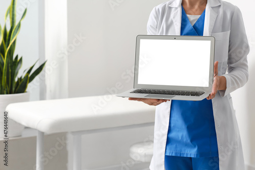 Female doctor with laptop i...