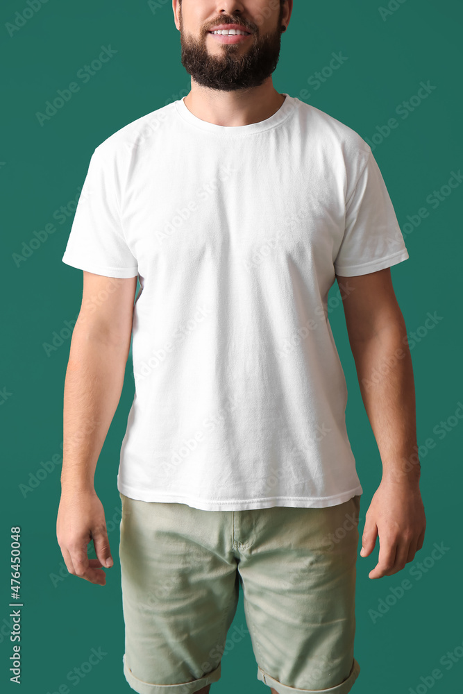 Handsome man in white t-shirt on green background Handsome man in white t-shirt on green background