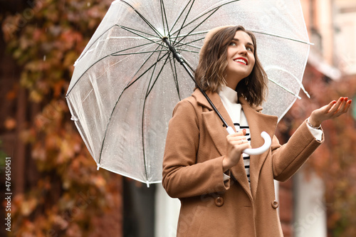 Happy woman with umbrella o...