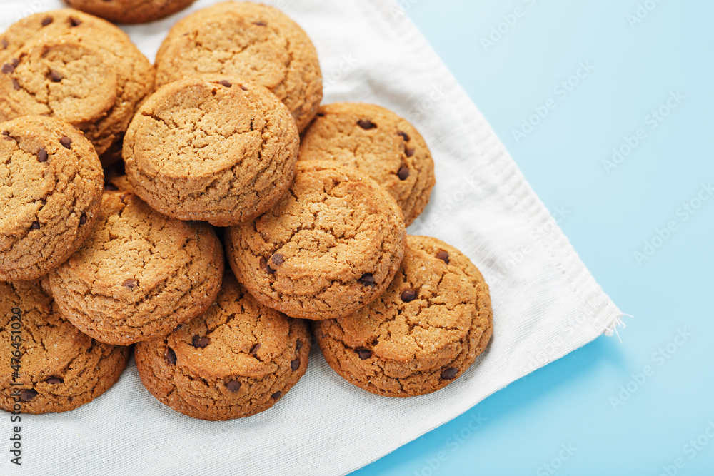 Oatmeal cookies on a napkin on a blue background Oatmeal cookies on a napkin on a blue background