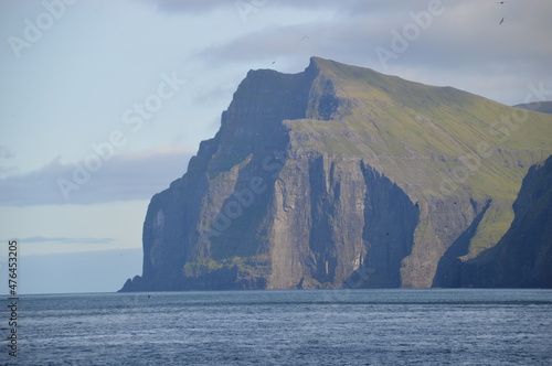 The green and blue dramatic and wild coastal landscapes in the Faroe Islands