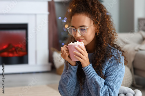 Pretty young woman with cup...