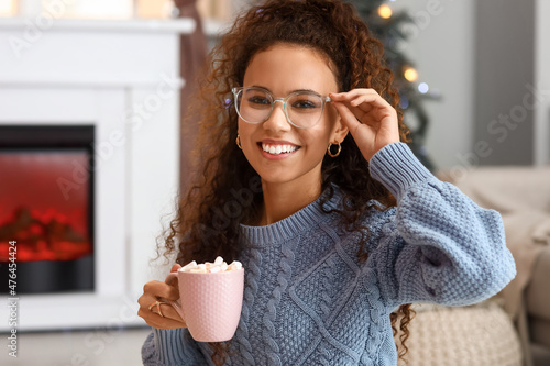 Pretty young woman with cup...