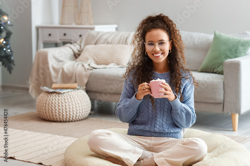 Pretty young woman with cup...