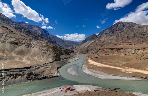 Scenic view of Confluence of Zanskar river from left and Indus rivers from up right - Leh, Ladakh, Jammu and Kashmir, India. Famous tourist spot of Ladakh for all seasons. landscape. © mitrarudra
