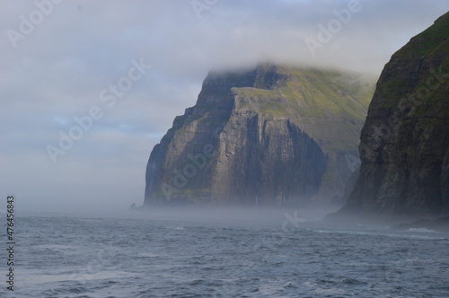 The dramatic coastline of the Faroe Islands with green mountains in the background © ChrisOvergaard