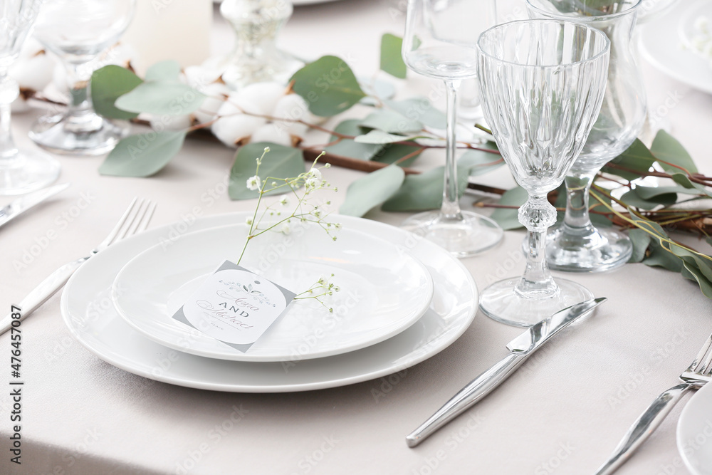 Beautiful table setting with wedding invitation and gypsophila flowers Beautiful table setting with wedding invitation and gypsophila flowers