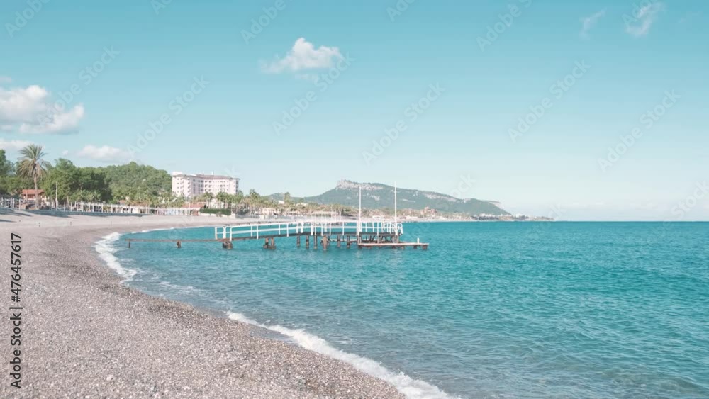 Iron bridge in to the sea. Beautiful Mediterranean Ocean waves with horizon in distance. Environmental and nature with deep green sea Iron bridge in to the sea. Beautiful Mediterranean Ocean waves with horizon in distance. Environmental and nature with deep green sea