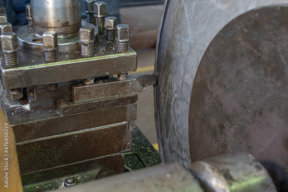 A lathe machine processes a cylindrical part clamped in a chuck using a cutter. A lathe machine processes a cylindrical part clamped in a chuck using a cutter.