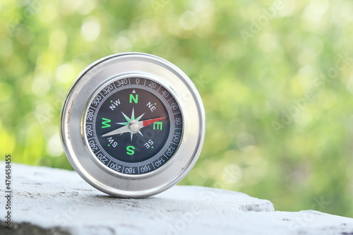 round compass on natural background as symbol of tourism with compass, travel with compass and outdoor activities with compass