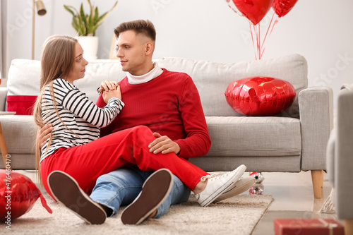 Happy couple spending time together at home. Valentine's Day celebration