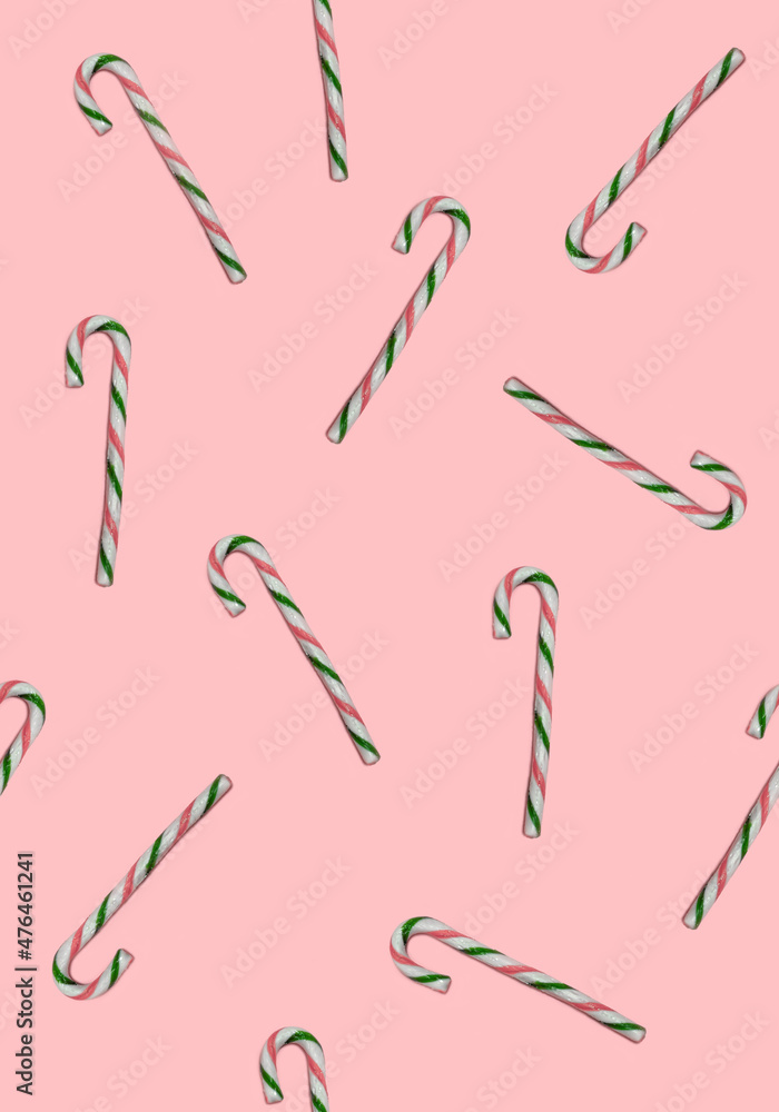 Cute Seamless Pattern with White-Red-Green Santa's Candy Canes on a Pastel Pink Background. Winter Holidays Repeatable Flat Lay ideal for Wrapping Paper, Fabric. Cute Seamless Pattern with White-Red-Green Santa's Candy Canes on a Pastel Pink Background. Winter Holidays Repeatable Flat Lay ideal for Wrapping Paper, Fabric.