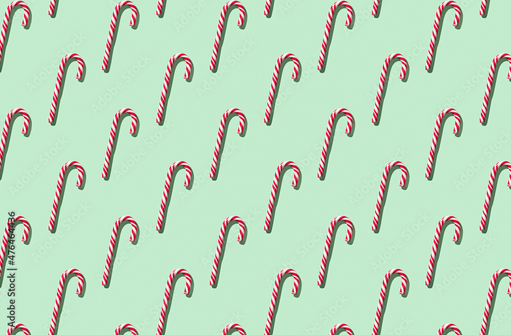 Pattern of hard candy cane striped on green pastel background Pattern of hard candy cane striped on green pastel background