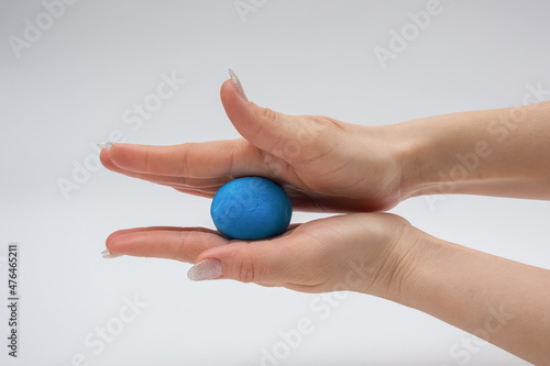 Wallpaper Mural The process of modeling plasticine. A piece of blue plasticine in hand.
 Torontodigital.ca