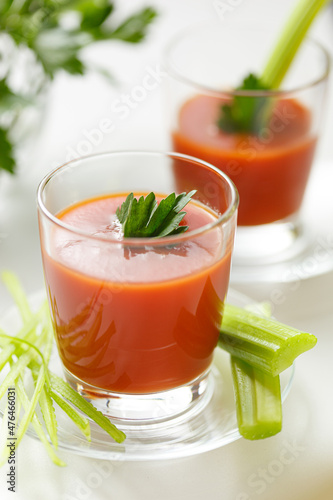 delicious tomato juice poured into a glass, with parsley and celery