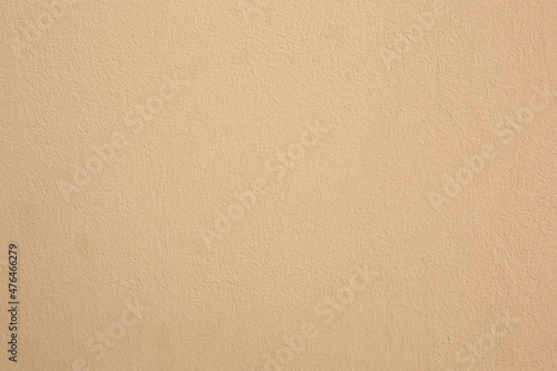 The concrete wall is beige. Rough texture for the background. 
