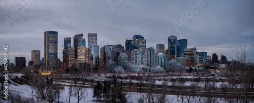 Calgary's skyline panorama at sunrise on a cold winter day along the Bow River.