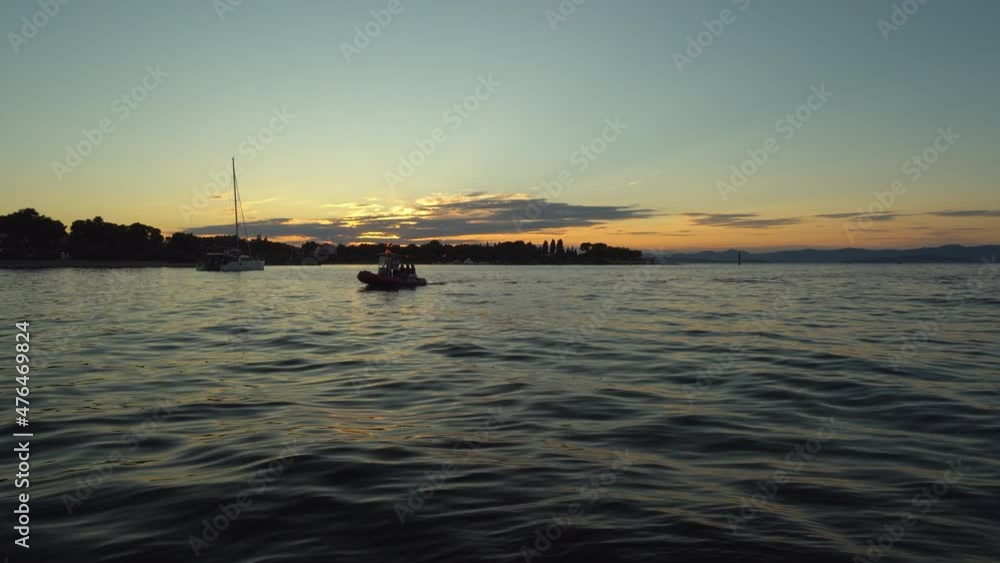 Boat moves to the shore at the sunset in Supetar, Croatia. 4K, Wide shot Boat moves to the shore at the sunset in Supetar, Croatia. 4K, Wide shot