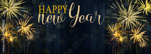 HAPPY NEW YEAR 2022 - Festive silvester firework background panorama greeting card banner long - Golden fireworks on dark blue wood wall texture.