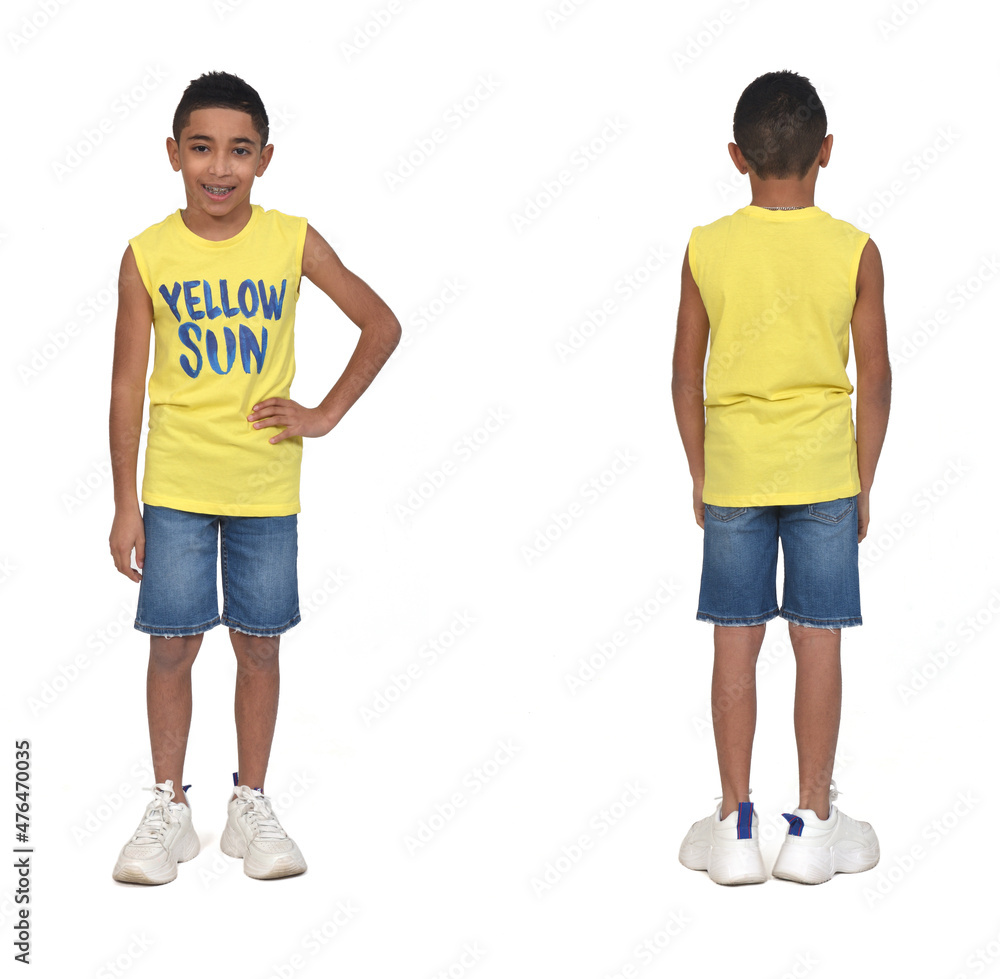 rear view of full portrait of a boy dressed in shorts and sleeveless with arms crossed on white background rear view of full portrait of a boy dressed in shorts and sleeveless with arms crossed on white background