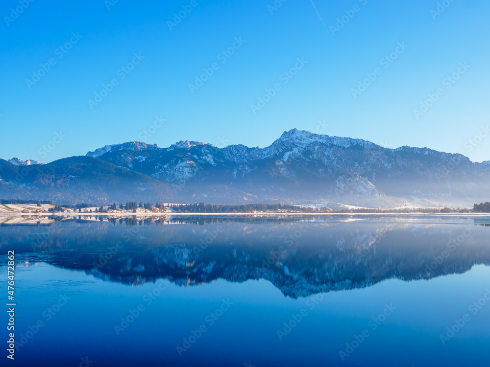 Winter landscape with mountains and a lake at the Forggensee