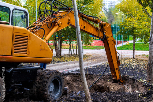 Excavator loader during earthworks at a construction site. An excavator digs land for the construction of a new park area.