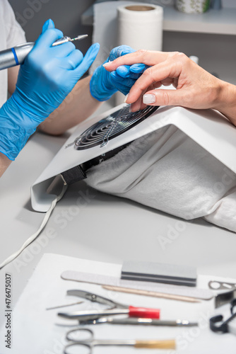 Performing manicure work in a beauty salon.