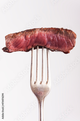 piece of grilled steak on a fork