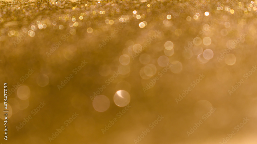 Golden shiny abstract background with round lights.