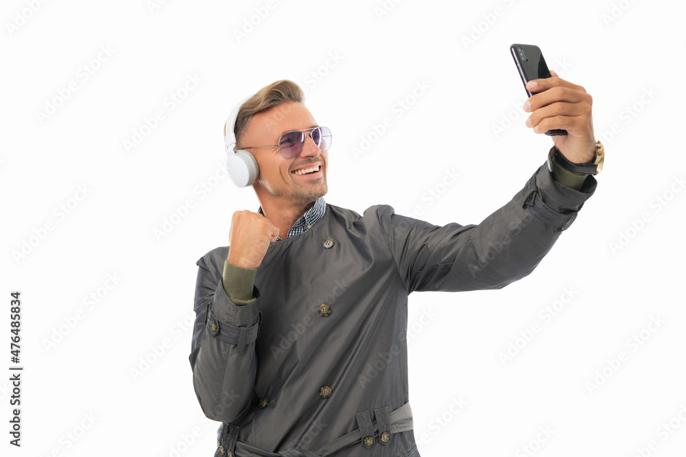 Streaming made easy. Happy man live stream flexing arm. Live streaming. Taking selfie on smartphone Streaming made easy. Happy man live stream flexing arm. Live streaming. Taking selfie on smartphone