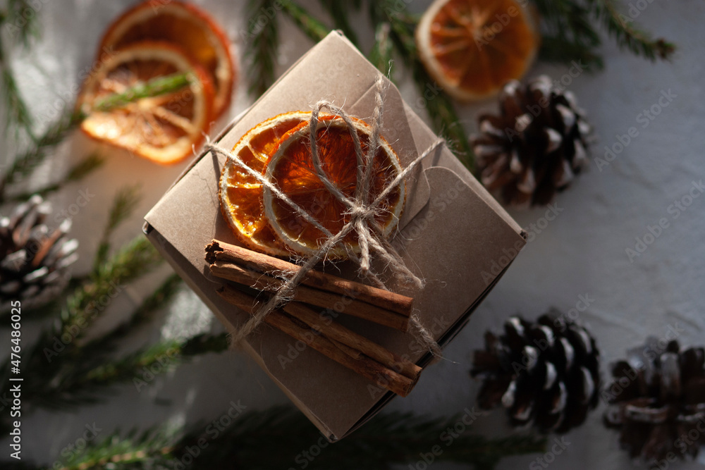 Christmas gift paper box decorated with dry oranges and cinnamon