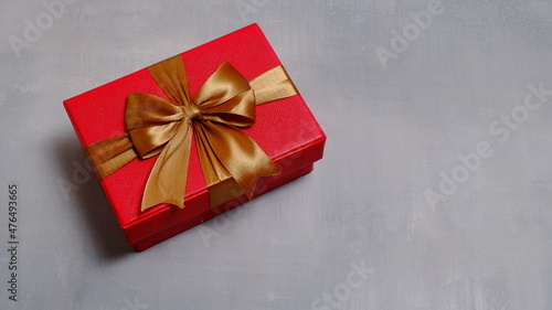 Cute gift box with satin ribbon on the table. Christmas and new year concept, Valentine Concept. Copy space, Negative Space. High View.