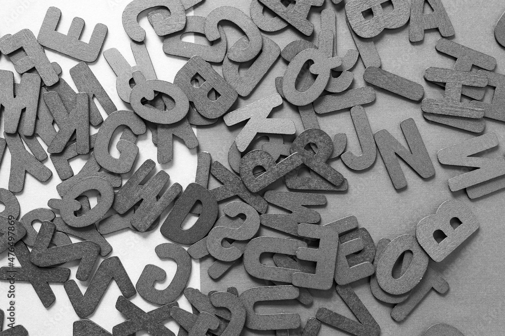 black and white letters scattered on a surface black and white letters scattered on a surface