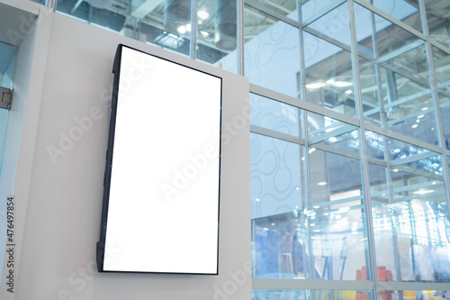 Vertical blank digital interactive white display wall at exhibition or museum with futuristic scifi interior. White screen, mock up, future, copyspace, template, technology concept photo