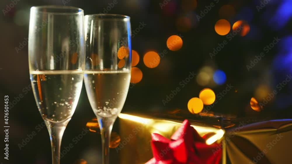 Two glasses of champagne with gift. New year or christmas concept. Two glasses of champagne with gift. New year or christmas concept.