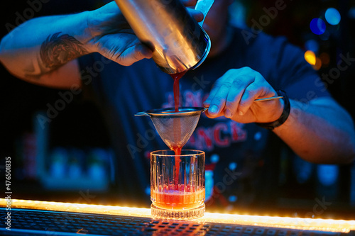 the bartender prepares a cocktail in the night bar