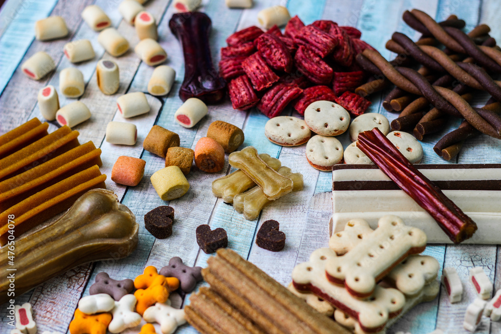 Dog tasty colored biscuits on wooden background Dog tasty colored biscuits on wooden background
