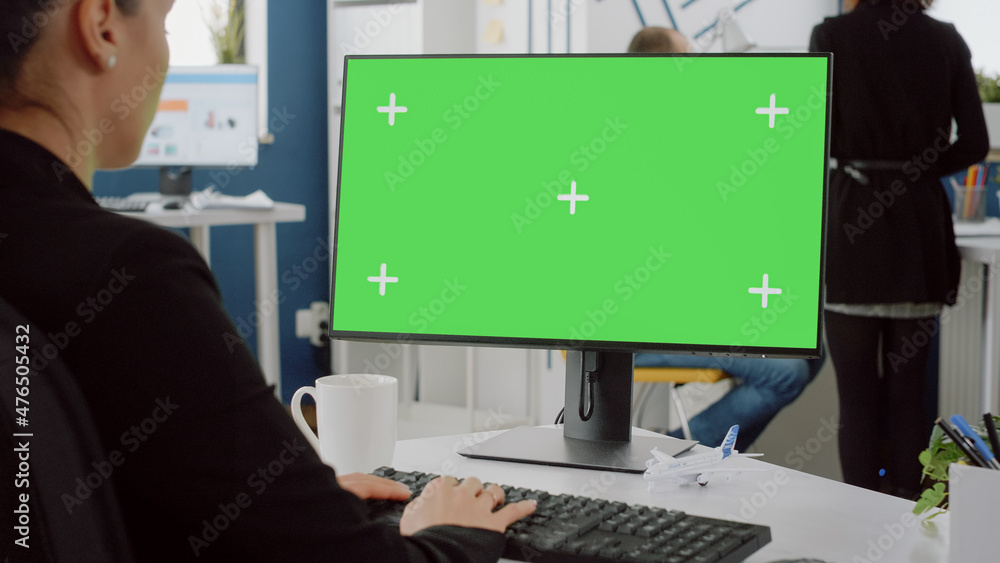 Close up of computer with horizontal green screen on desk. Woman with business job working on monitor with mockup template and isolated background for technology with chroma key. Close up of computer with horizontal green screen on desk. Woman with business job working on monitor with mockup template and isolated background for technology with chroma key.