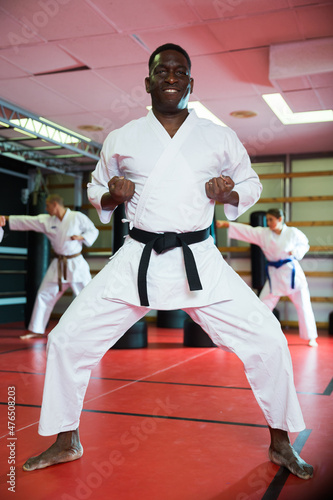 African american man in kimono fighting stance at karate training