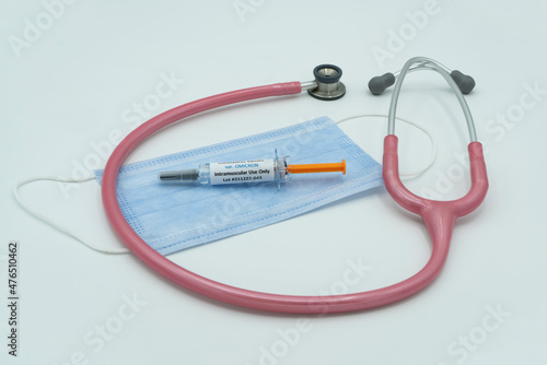 Covid 19 syringe on mask with stethoscope. Healthcare and medical concept . Omicron.