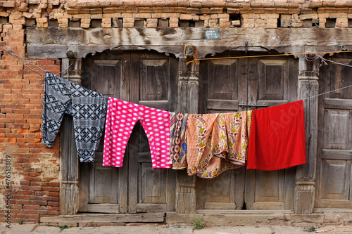 Dhulikhel, Nepal: Colorful laundry dries on a line outside a Newari brick and wood building in Dhulikhel's old town photo