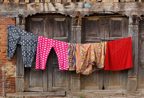 Dhulikhel, Nepal: Colorful laundry dries on a line outside a Newari brick and wood building in Dhulikhel's old town photo