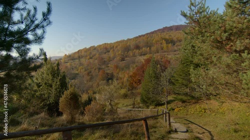 Overview of autumn sunny mountains and clear blue sky with rock stepes on the foreground. photo